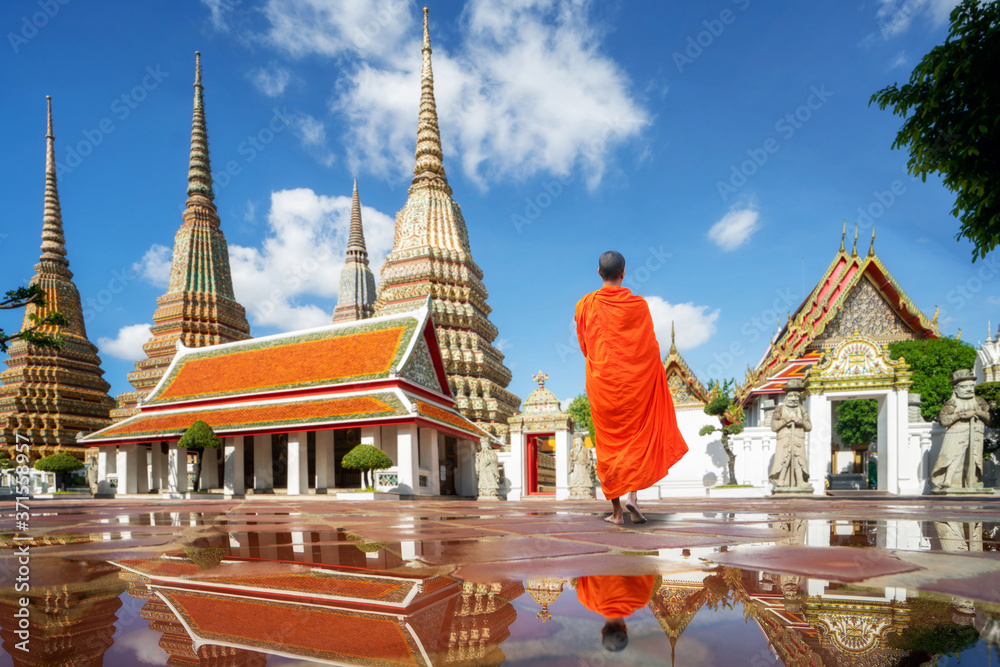 Fototapeta premium Buddhism Monk walk in Pho temple in Bangkok city