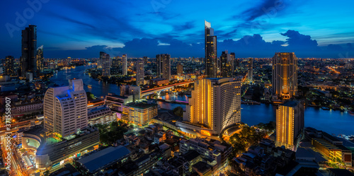Cityscape in Bangkok city from roof top bar in hotel with Chao phraya river background