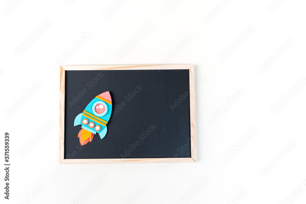 Obraz premium Rocket paper craft. Back to school education. Black chalkboard background