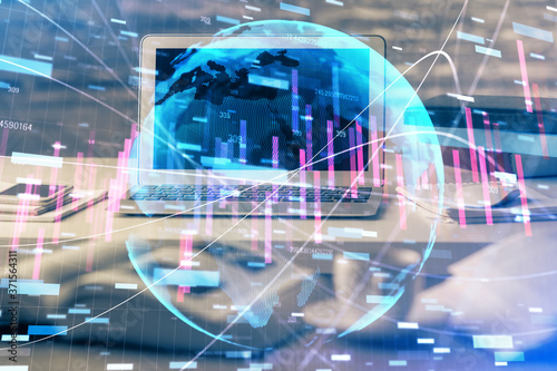 Double exposure of graph and financial info and work space with computer background. Concept of international online trading. © peshkova