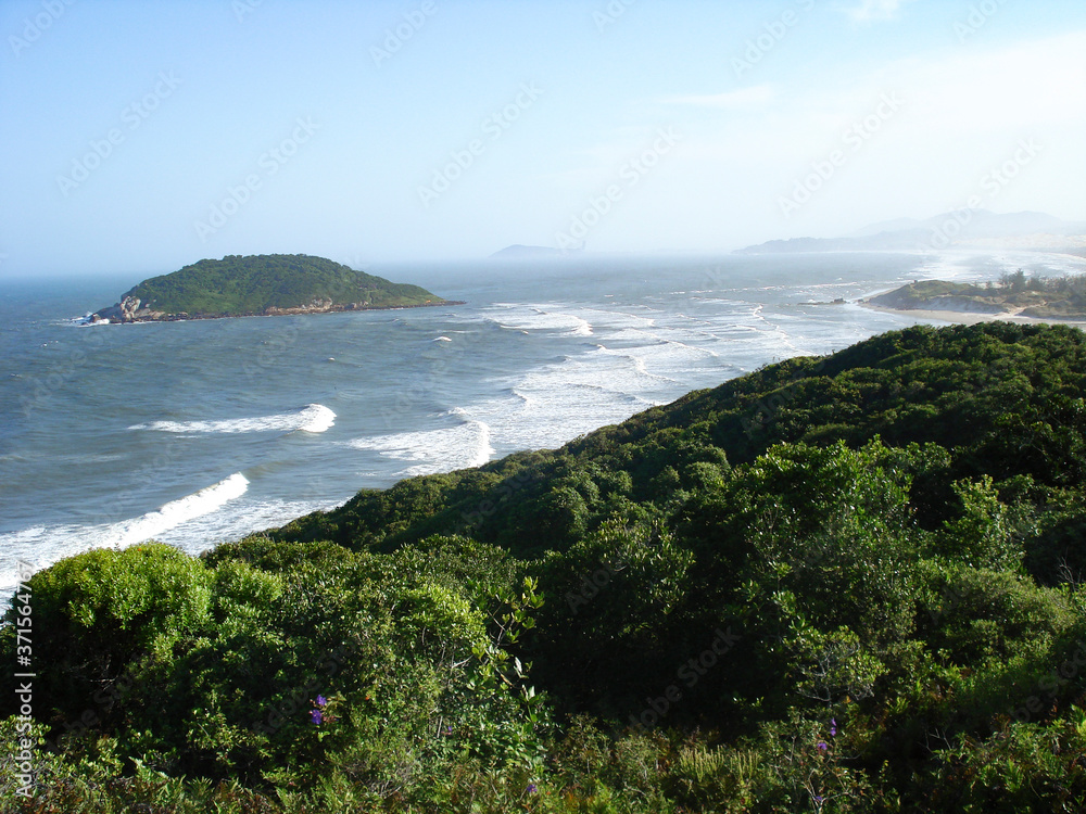 Landscape of an island, sea, and beach. Praia da Barra de Ibiraquera, Imbituba, Brazil.