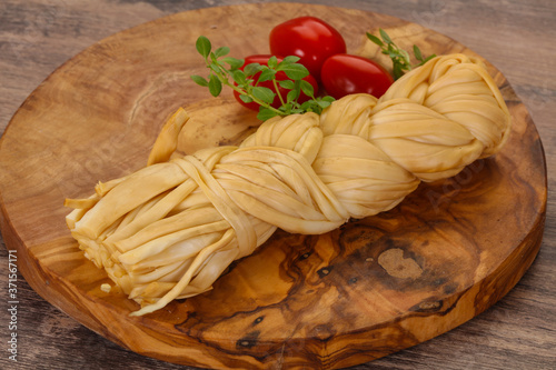 Caucasian traditional pigtail cheese served tomatoes
