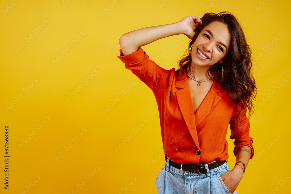 Portrait of young woman in a shirt and jeans. African American woman posing on yellow background. Fashion, glamour and lifestyle concept. Portrait of young woman in a shirt and jeans. African American woman posing on yellow background. Fashion, glamour and lifestyle concept.