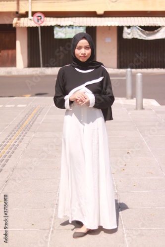 Fashion portrait of young beautiful asian muslim woman with wearing hijab © faishalabdula