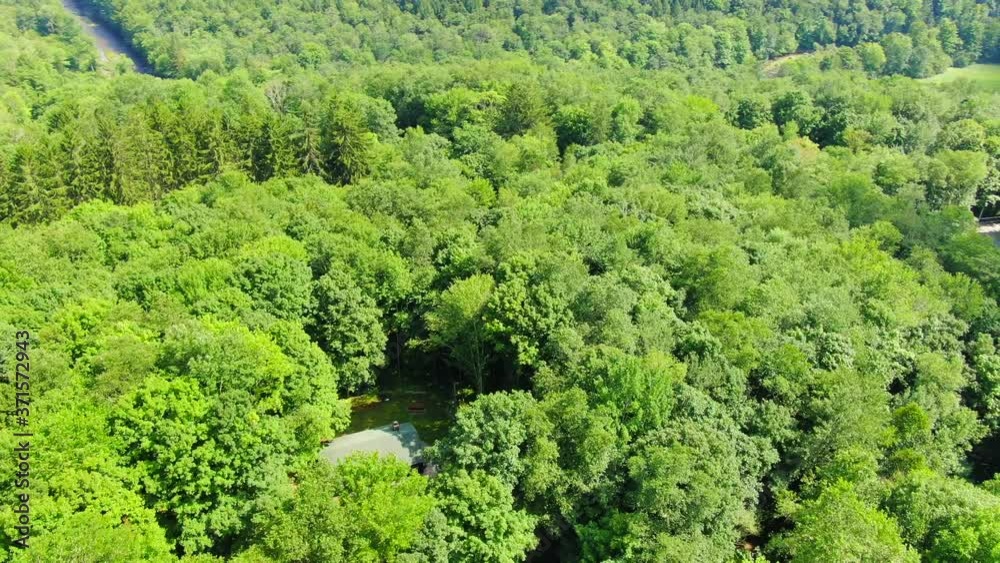 Orbit View of a Small Cabin Surrounded by Trees