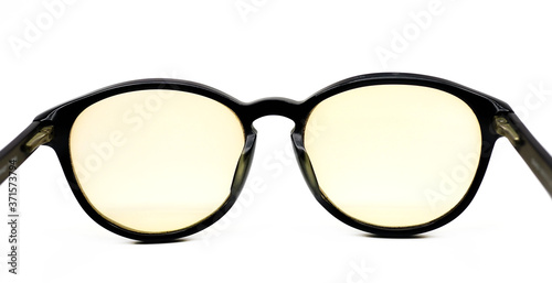 Yellow lens black glasses isolated on white background Fashion Spherical glasses on white background.