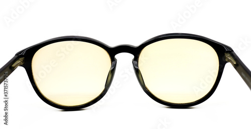 Yellow lens black glasses isolated on white background Fashion Spherical glasses on white background. photo