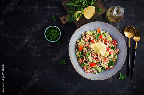 Tabbouleh salad. Traditional middle eastern or arab dish. Levantine vegetarian salad with parsley, mint, bulgur, tomato. Top view