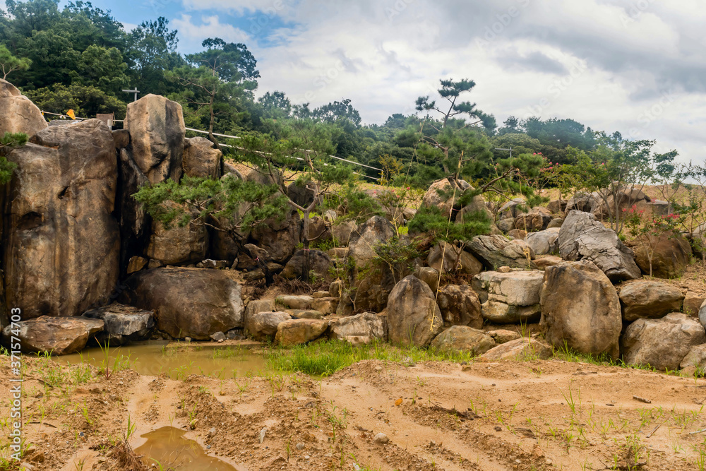Large boulders arranged to create an artificial waterfall