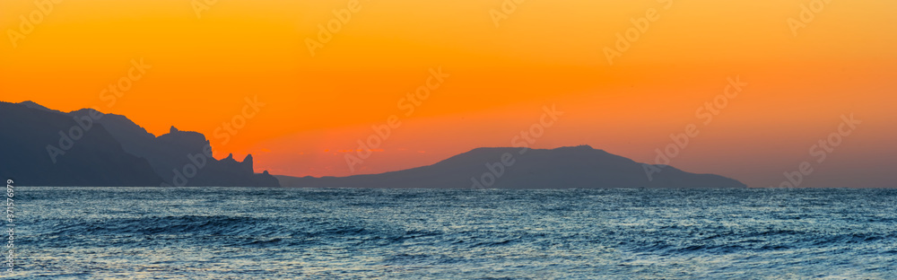 sea bay with rocky coast at the sunrise, wide outdoor dawn natural background