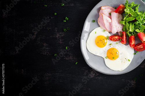 Ketogenic/paleo diet. Fried eggs, ham and fresh salad.  Keto breakfast. Brunch.  Top view, overhead
