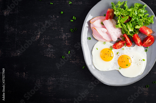 Ketogenic/paleo diet. Fried eggs, ham and fresh salad.  Keto breakfast. Brunch.  Top view, overhead