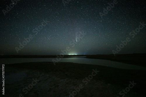 Night landscape of the C/2020 F3 NEOWISE in salt lake, star sky with a comet, Inner Mongolia, Northwest of China