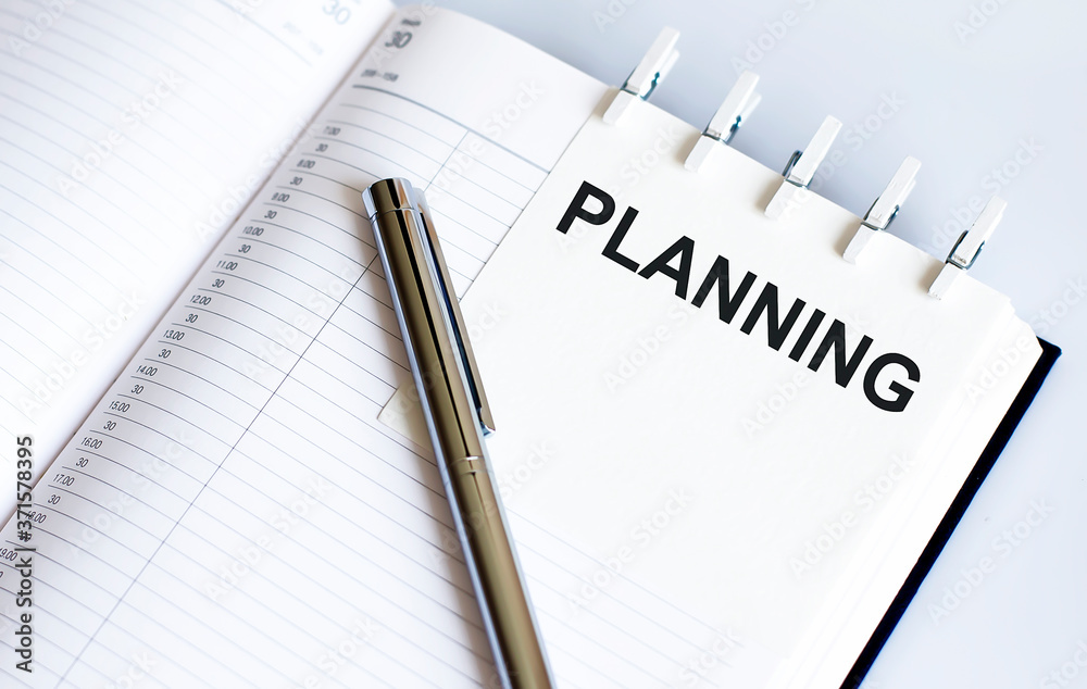 text PLANNING on the short note texture background with pen text PLANNING on the short note texture background with pen