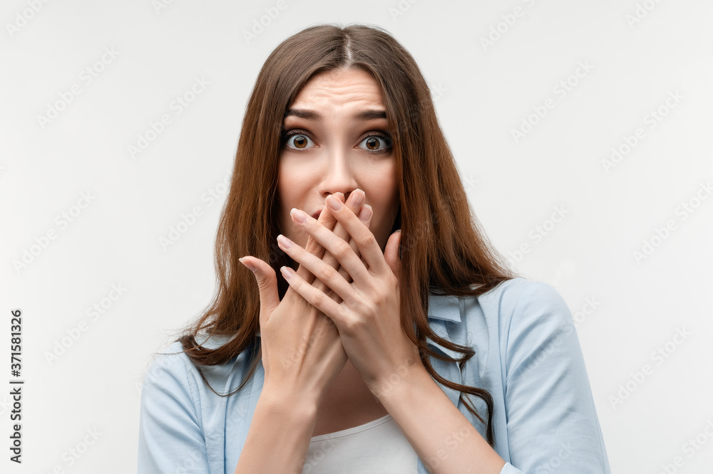 Scared caucasian girl covering mouth with hands. Keep silence concept. Scared caucasian girl covering mouth with hands. Keep silence concept.