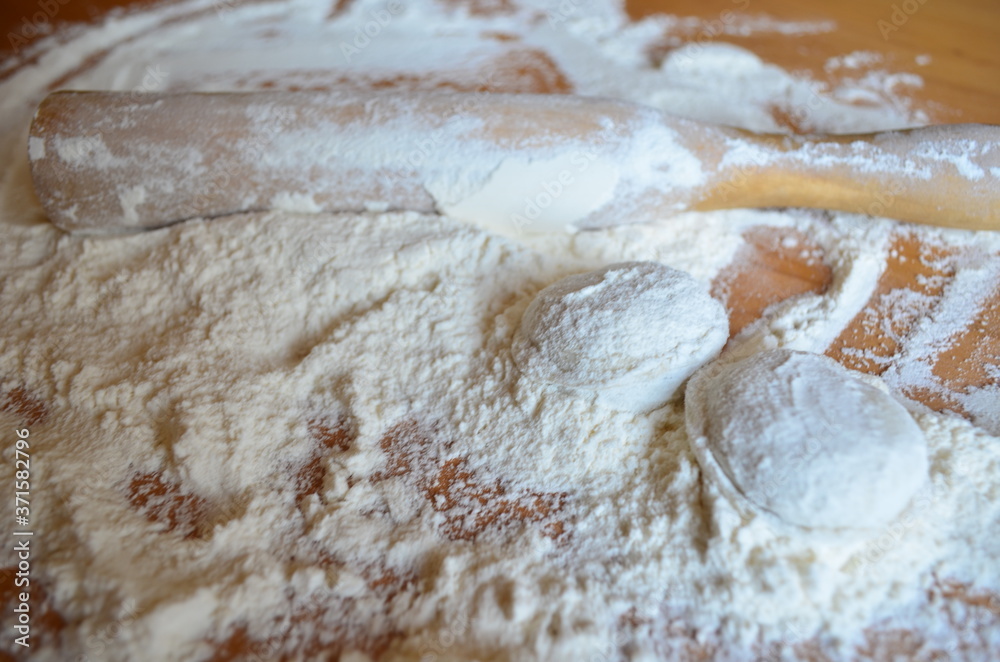 making homemade dumplings with your hands. The table is in flour. making homemade dumplings with your hands. The table is in flour.