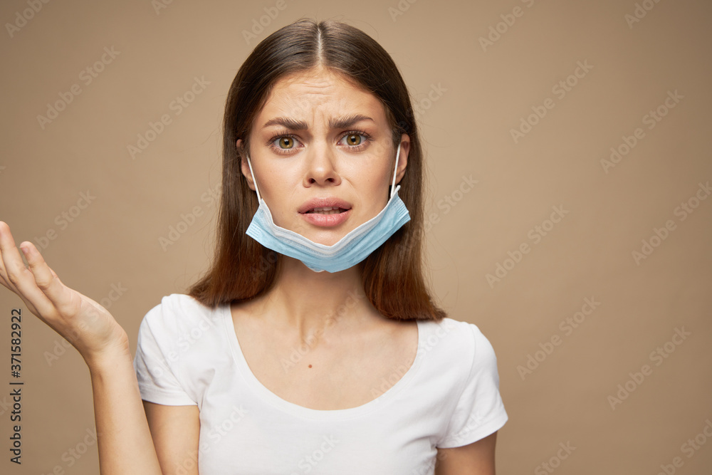 Surprised woman with a medical mask on her face gesturing with her hands Surprised woman with a medical mask on her face gesturing with her hands