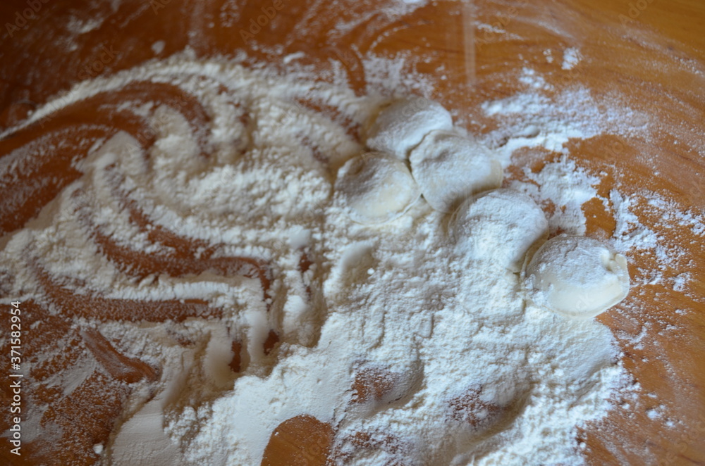 making homemade dumplings with your hands. The table is in flour. making homemade dumplings with your hands. The table is in flour.