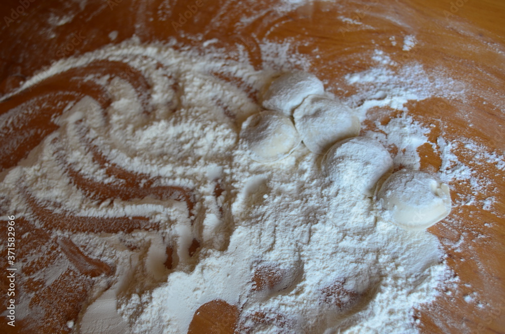 making homemade dumplings with your hands. The table is in flour. making homemade dumplings with your hands. The table is in flour.