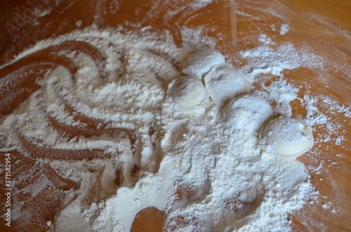 making homemade dumplings with your hands. The table is in flour.