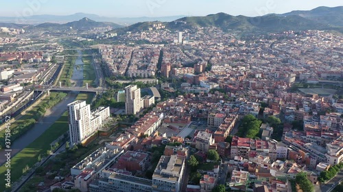 Aerial view of Santa Coloma de Gramenet with a apartment buildings and Besos river, Spain. High quality 4k footage photo