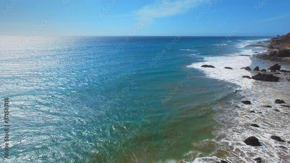 Aerial shot of azure wavy ocean surface at El Matador Beach Malibu, Califronia, USA Aerial shot of azure wavy ocean surface at El Matador Beach Malibu, Califronia, USA