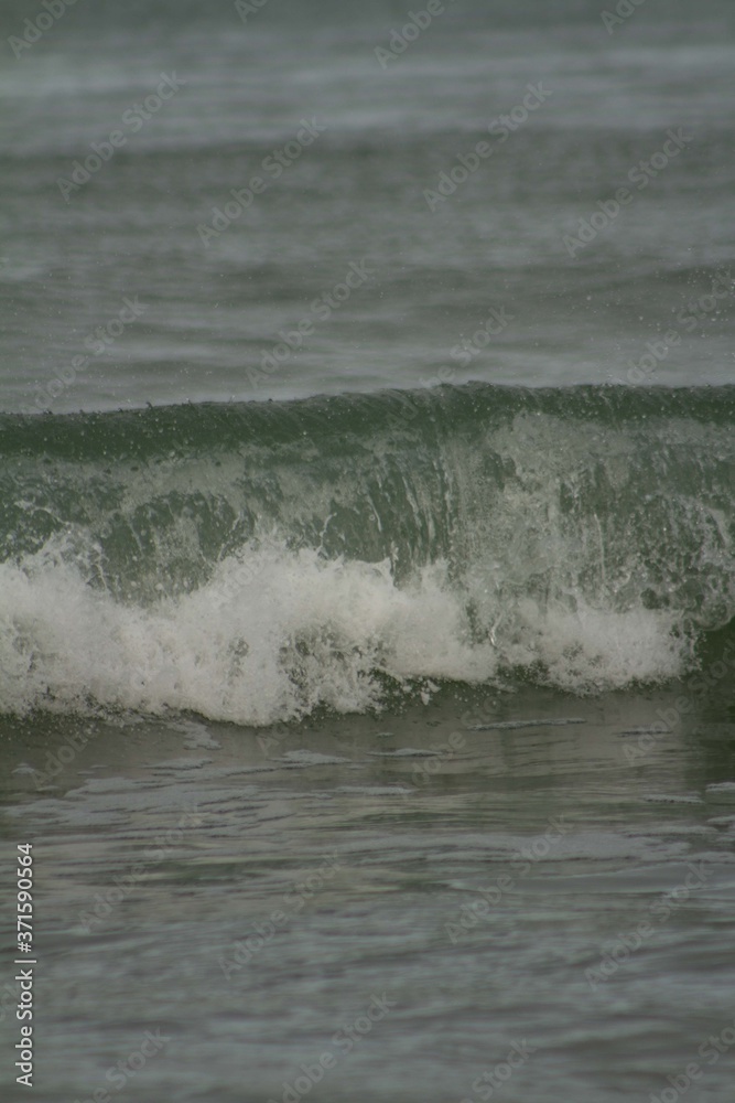 Small waves breaking off the West coast, New Zealand. Small waves breaking off the West coast, New Zealand.