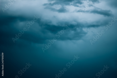 Dark and eerie clouds floating across the sky, storm clouds in the dark.