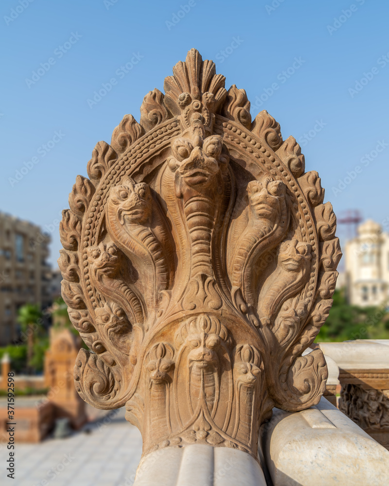 Fototapeta premium Hindu statue of snakes, One of the Indonesian statues studding the external terrace of historical palace of Baron Empain, Cairo, Egypt
