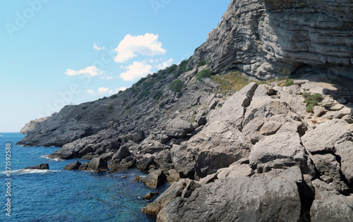 rock by the sea, sunny day