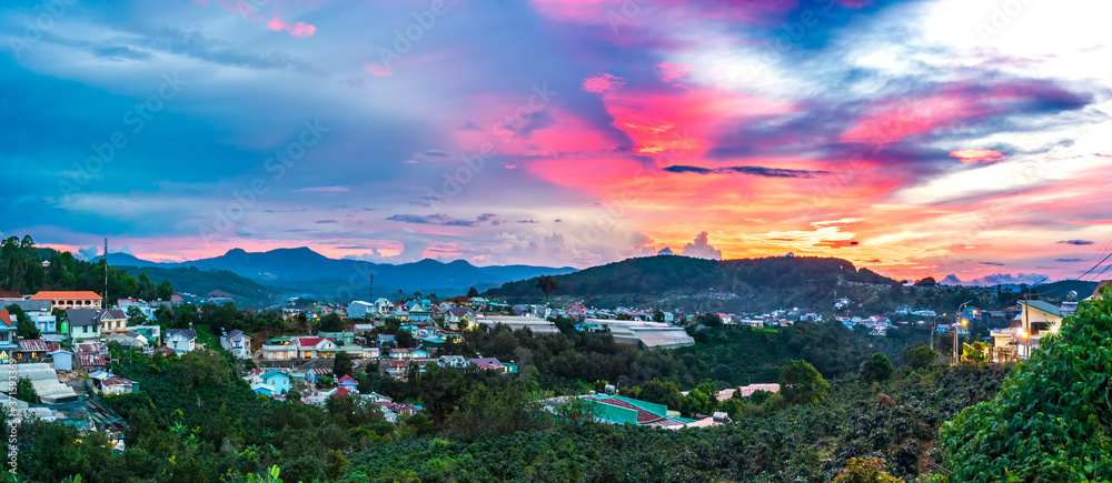 Small village in a tea hill valley on sunset sky in Da Lat, Vietnam. The place provides a great deal of tea for the whole country