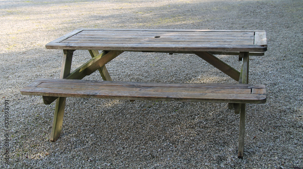 A Double Sided Wooden Picnic Table with Seats.