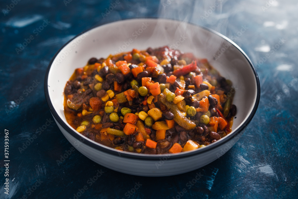 Fototapeta premium plant-based food, vegan lentils and beans stew with roasted vegetables