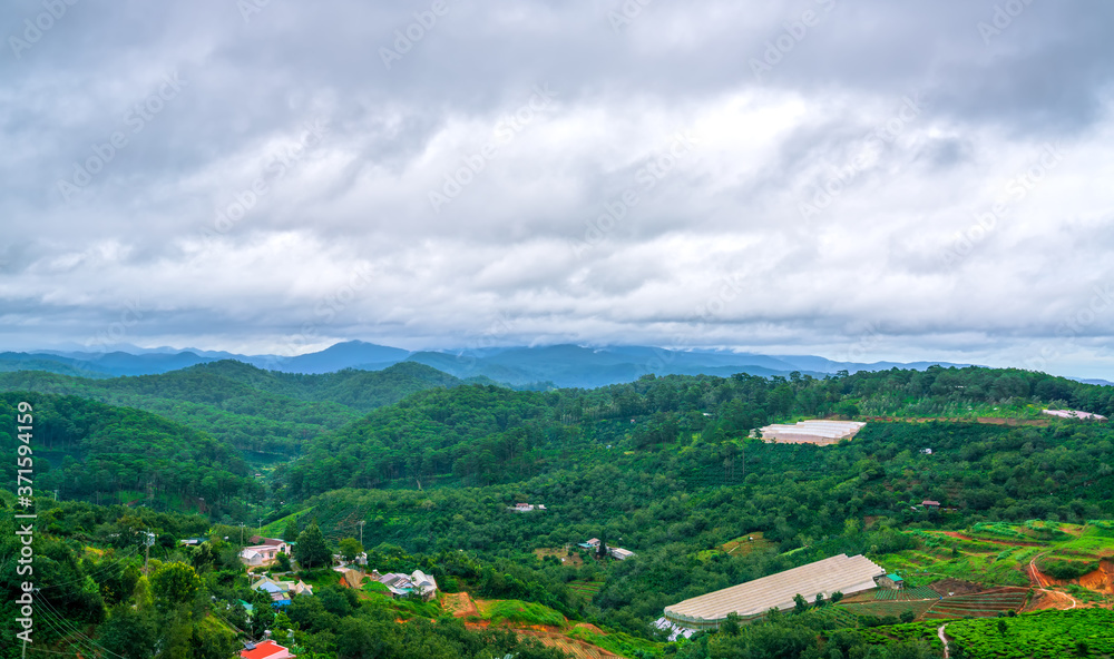 Small town on a stormy morning with moving clouds on the top of the hill and the valley is the peaceful in Da Lat, Vietnam