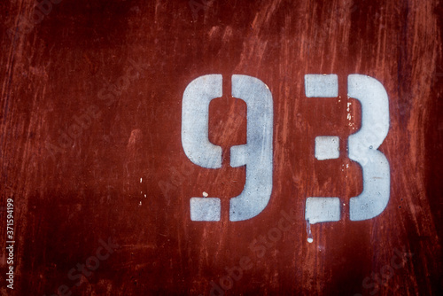 The old iron background is painted yellow, orange, purple, red in with rust and chips