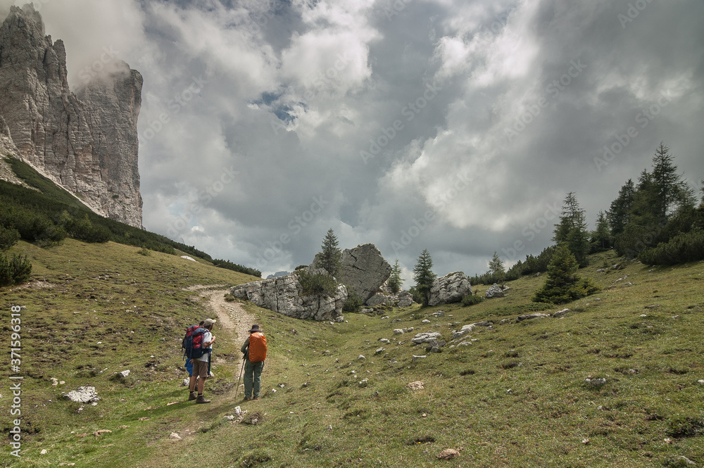 Fototapeta premium On trail from Coldai refuge via Coldai lake to Vazzoler refuge, along Civetta mountain range from north to south, stage 9 of Alta Via 1 classic long trek in the Dolomites, South Tirol, Italy.