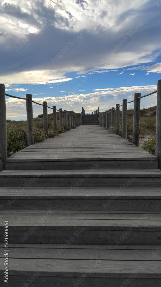 Wooden stairs through the dunes up to the beach at the Northern Litoral Natural Park in Esposende, Portugal.