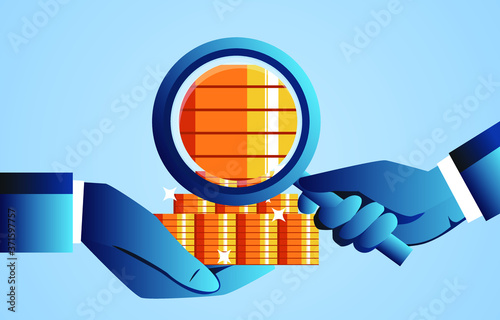 Holding a magnifying glass to observe the gold coins in your hand