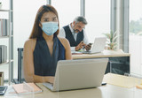 Business people wearing masks working together