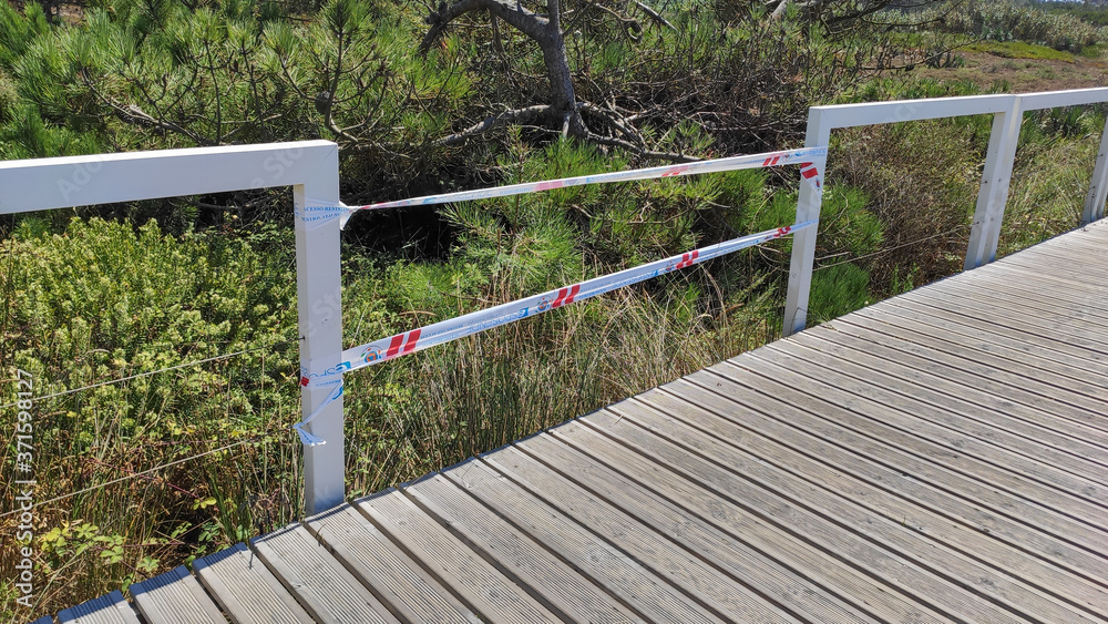 Marinhas / Portugal - July 31, 2020: Vandalized boardwalk at the Ecovia Litoral Norte (North Coast Ecoway), in Esposende, Portugal. Marinhas / Portugal - July 31, 2020: Vandalized boardwalk at the Ecovia Litoral Norte (North Coast Ecoway), in Esposende, Portugal.