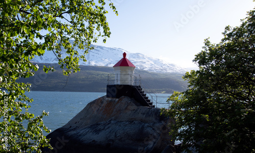 Snall lighthouse in Northern Norwegian fjord photo