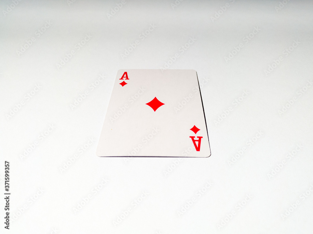 A close up view at one ace card with a diamond suit from a deck of playing cards. The concept of games, gambling, fun and free time.