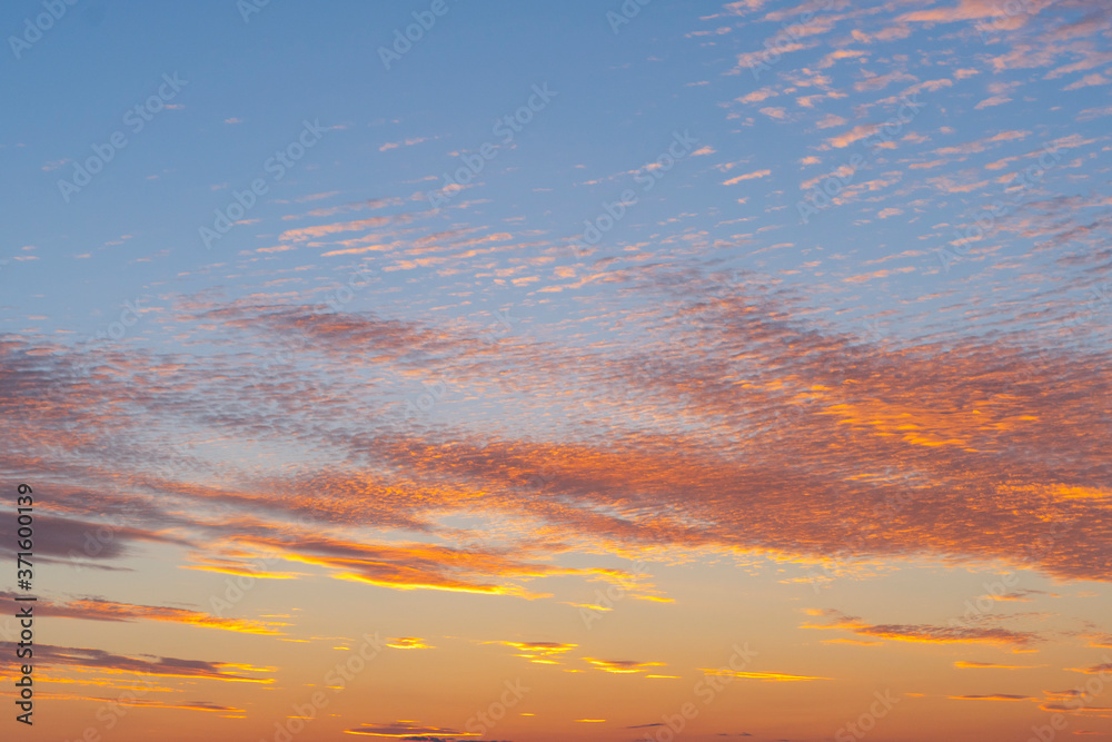 Sunset sky texture background. Cloudscape. Orange texture of clouds. Sunrise or sunset over clouds