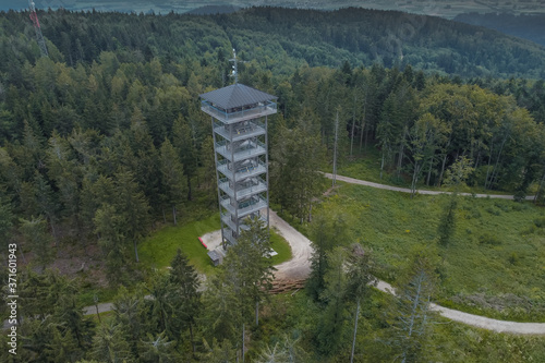 Aussichtsturm Lichtenberg, a man made lookout tower of metal and wood in the Attergau region of Austria, rising high above the local hills in cloudy weather. photo