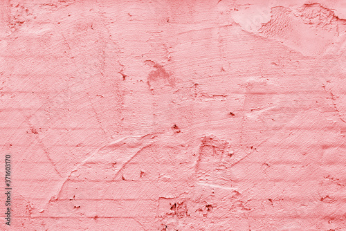 Pink wall of the building. Rough plaster surface. Abstract background.