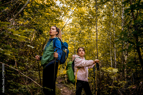 Mother and daughter hiking in nature together © Dejan
