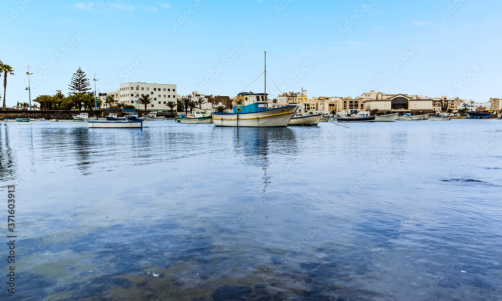 Fototapeta premium A sea level view of boats moored in the lagoon of Charco de San Gines in Arrecife, Lanzarote on a sunny afternoon