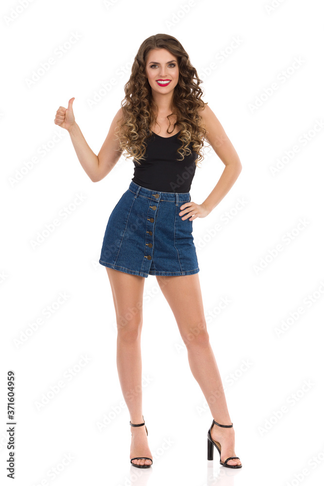 Confident Sexy Woman In Jeans Mini Skirt And High Heels Is Showing Like Hand Sign Confident Sexy Woman In Jeans Mini Skirt And High Heels Is Showing Like Hand Sign