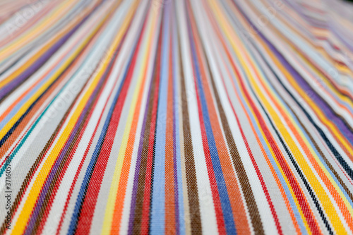 Fotografía Parallel colored lines on a fabric, blurred background out of focus at the end
