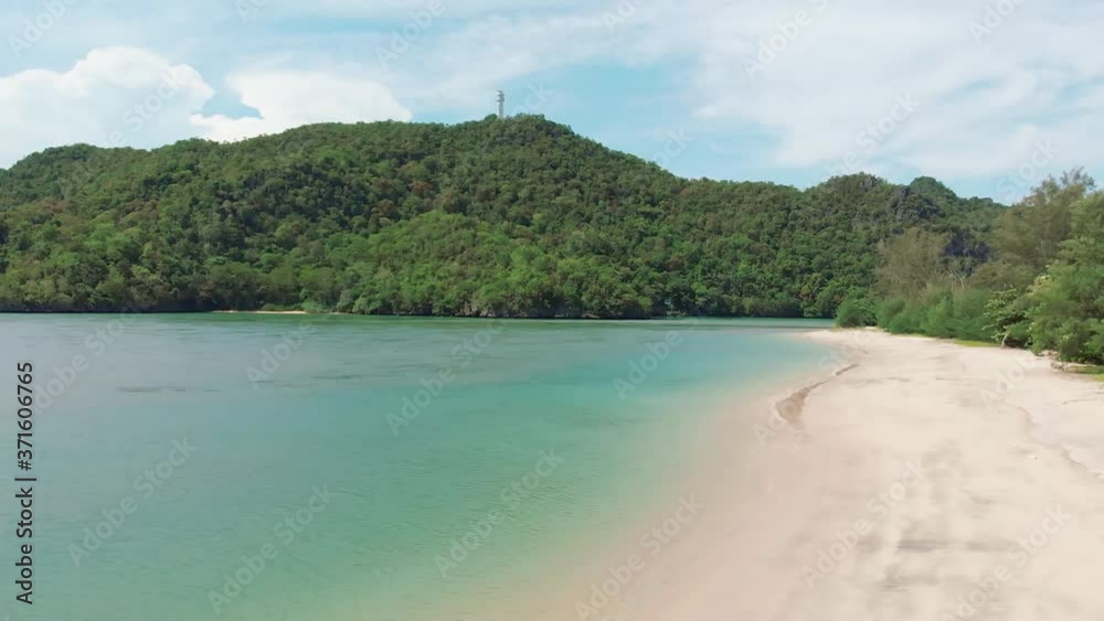 Aerial shot camera takes off over a deserted sandy beach of a tropical island beach. Aerial shot camera takes off over a deserted sandy beach of a tropical island beach.